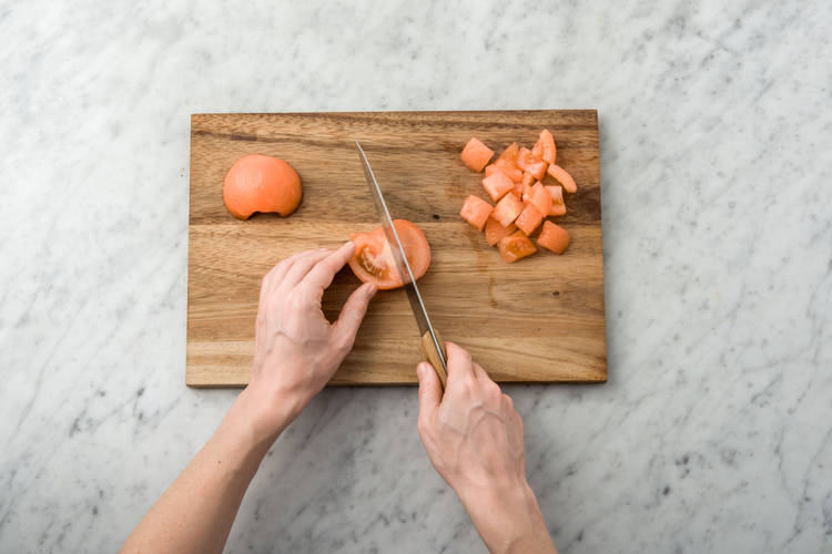 Score the skin of the tomato