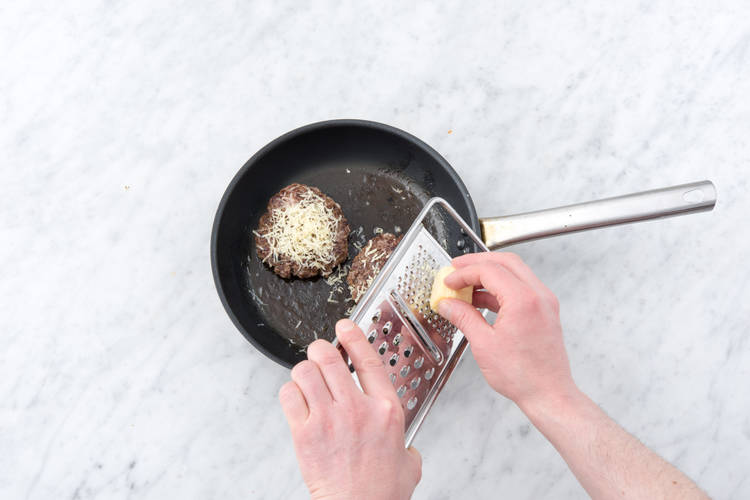 Grate the cheese on the burger