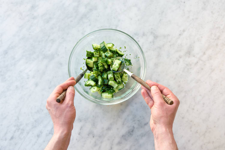 Mix the herbs into the cucumber