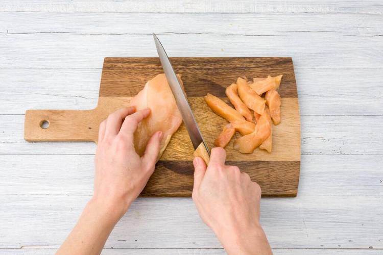 Thinly slice the chicken breasts into the strips