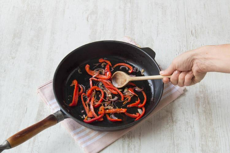 Add the sliced red onion, bell peppers, and chili powder