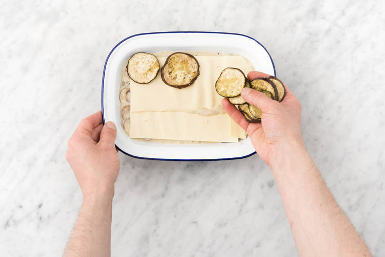 Maak van de saus, lasagnebladen en aubergine lagen in de ovenschaal.