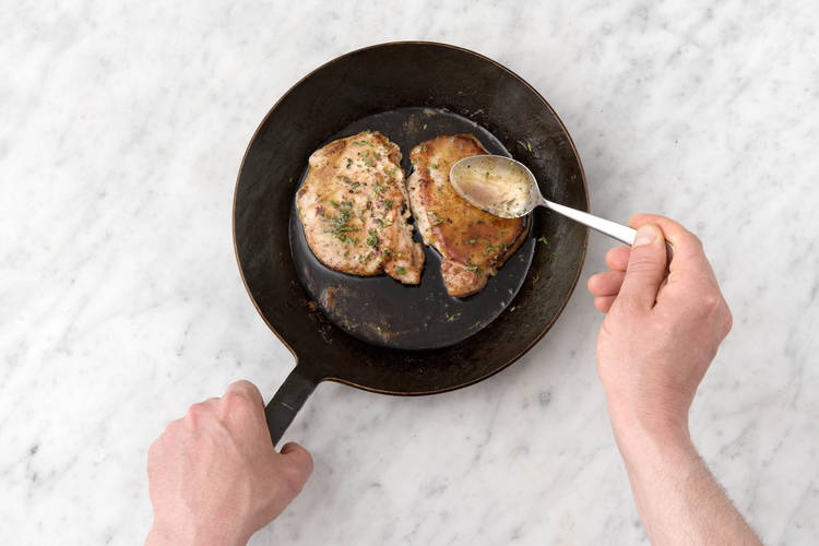 Baste the pork steaks