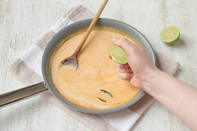 Squeeze lime juice into laksa.