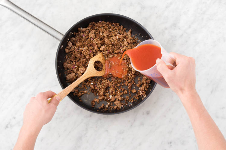 Pour passata into lamb.
