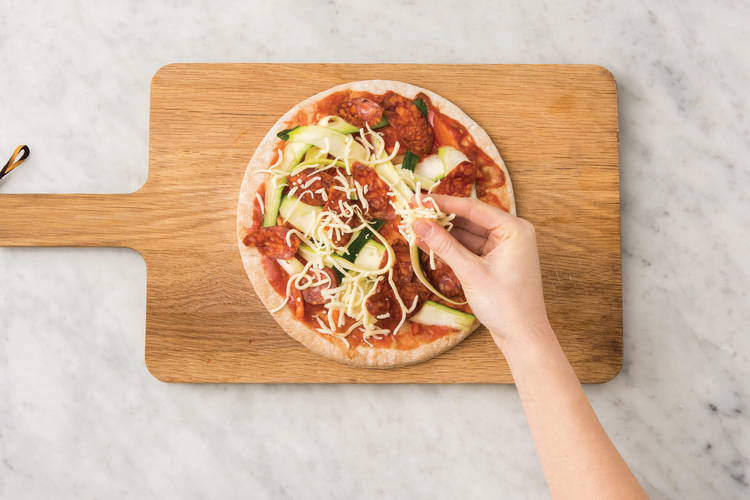 Top the pizzas