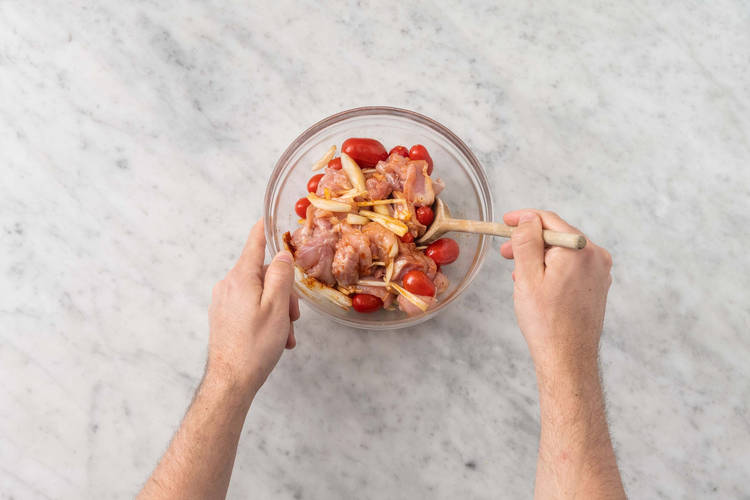 Season chicken and veggies