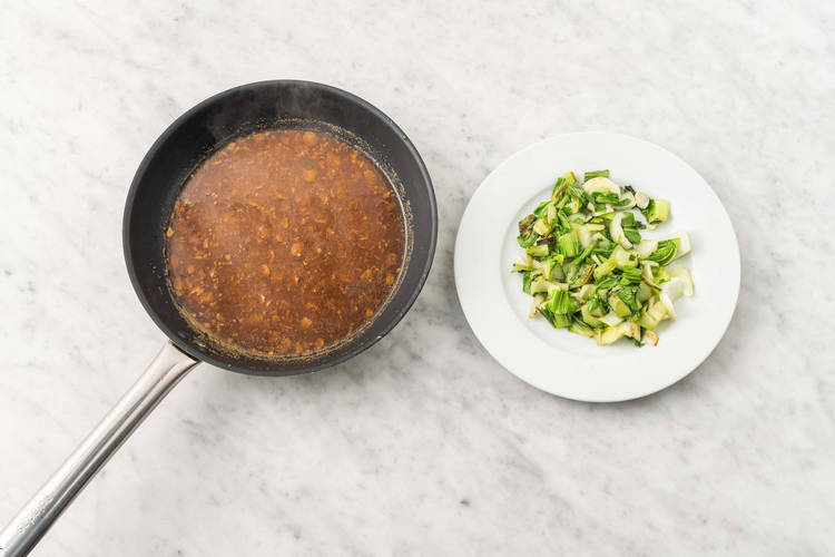 Cook bok choy and make almond sauce