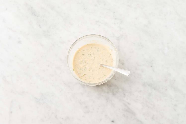 Make hummus dressing and warm pitas