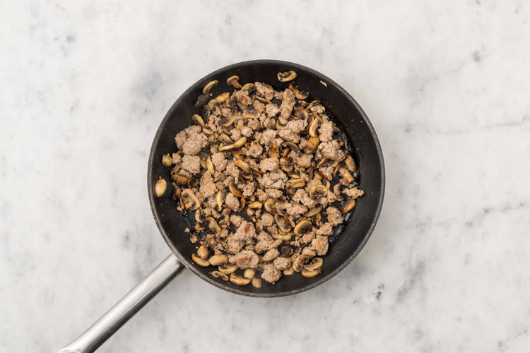 Cook sausage and mushrooms