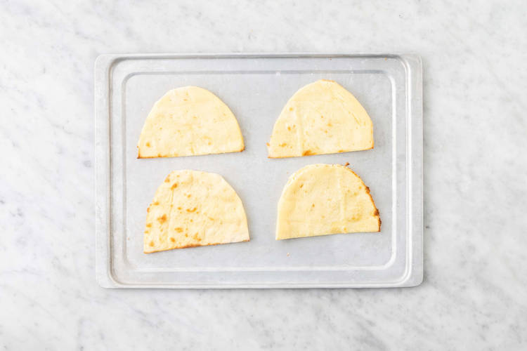 Toast flatbreads and dress veggies
