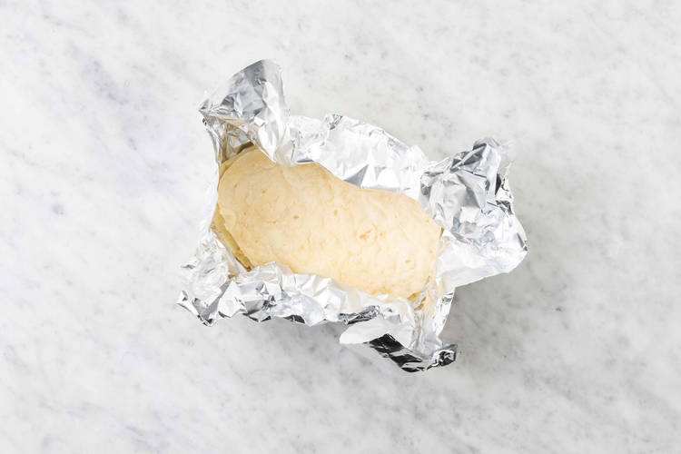 Warm naan and make spiced yogurt