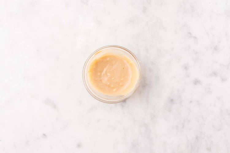 Warm tortillas and make garlic tahini sauce