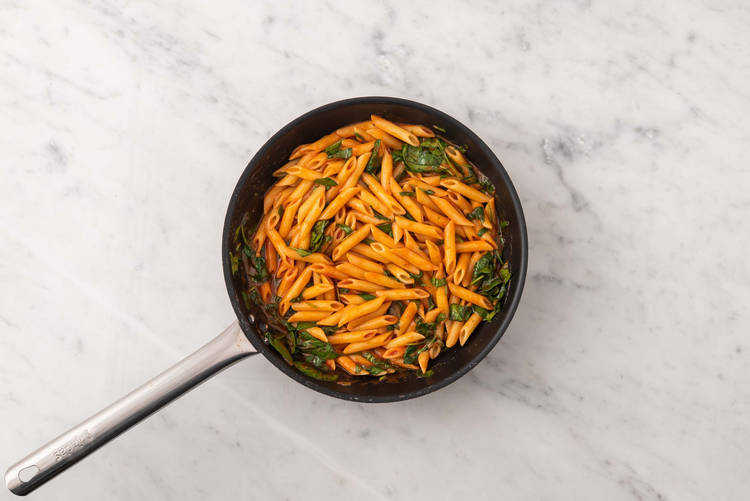 Sauce penne and cook spinach