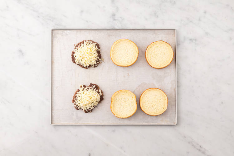 Toast buns and melt cheese