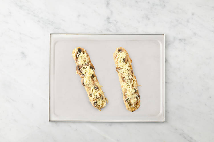 Toast demi baguette and assemble mushroom melts