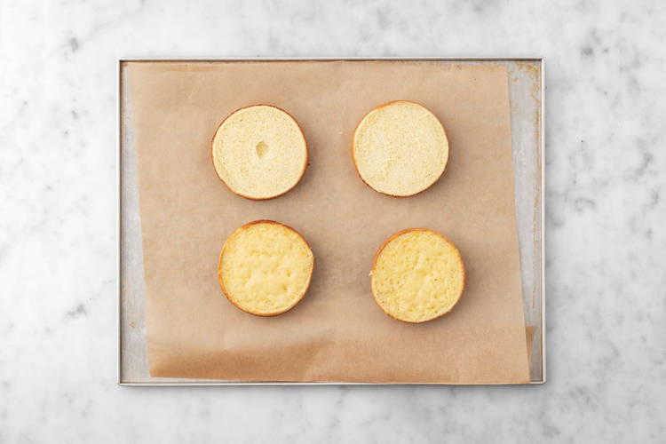 Toast buns and melt cheese