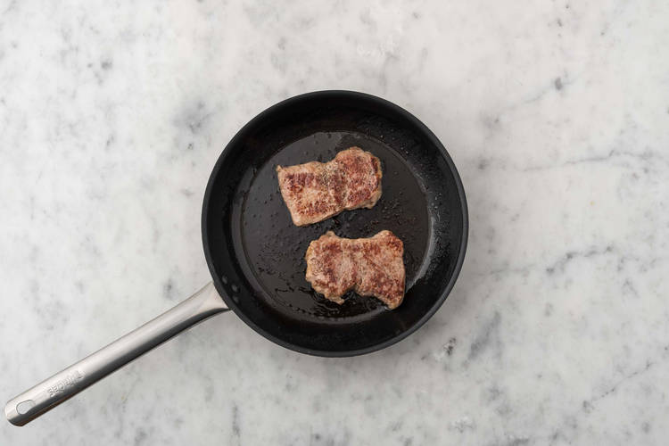 Cook shrimp and start steaks