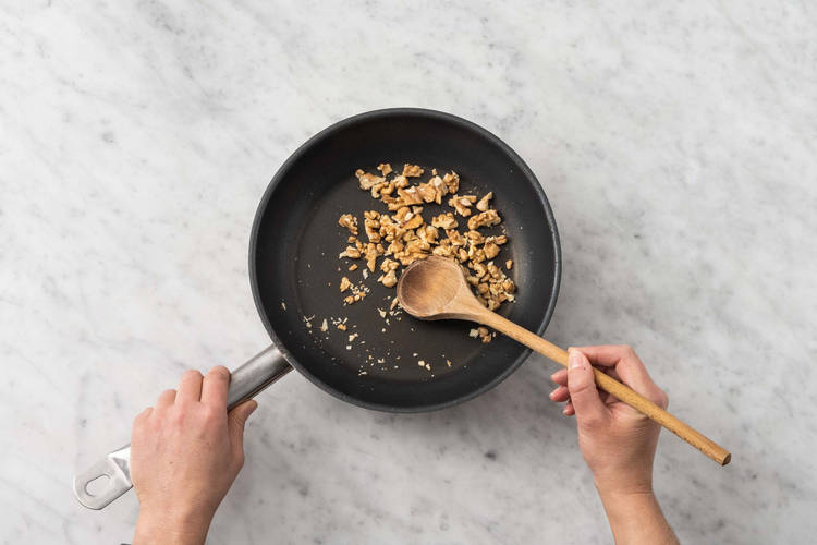 Toast walnuts and prep loaf pan