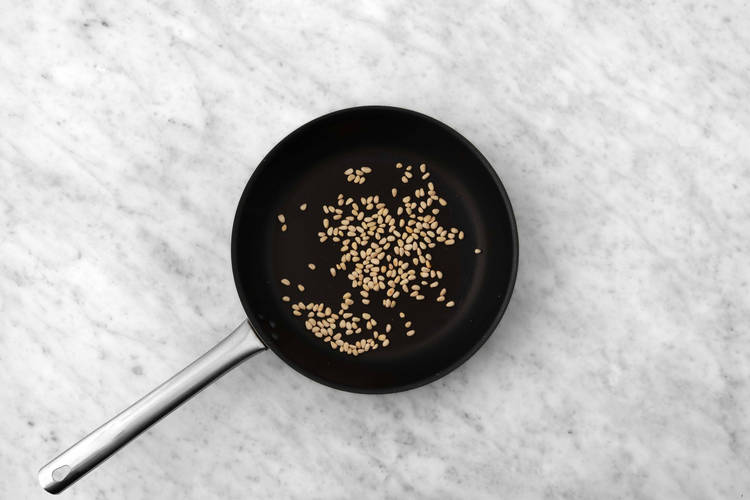 Toast pine nuts and cook tomatoes