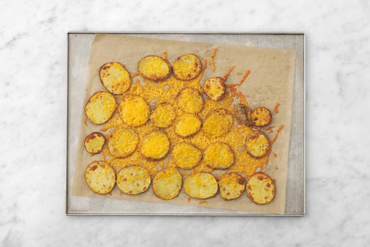 Melt cheese on potatoes