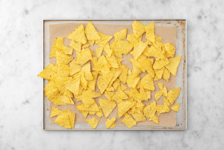 Bake tortilla chips and cook chorizo