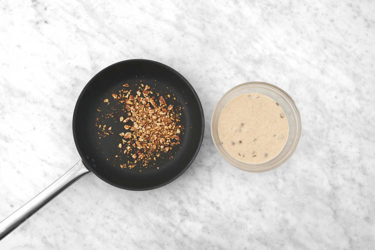 Toast walnuts and make pancake batter