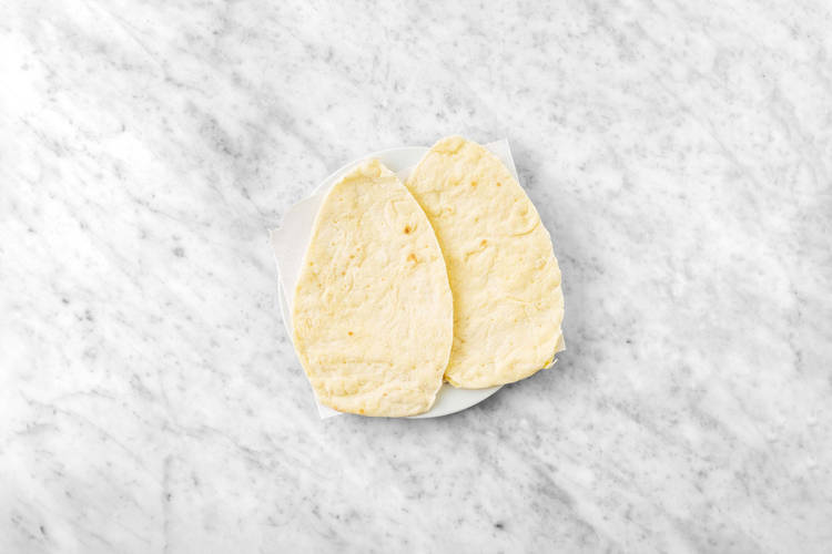 Warm flatbreads and make salad