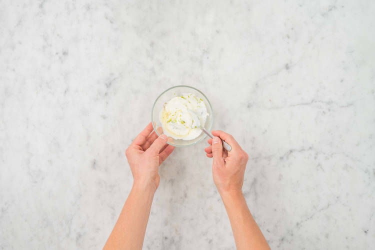 Make garlic lime crema and warm tortillas