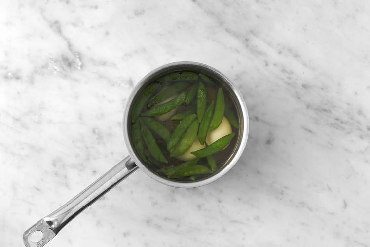 Blanch sugar snap peas and cook eggs