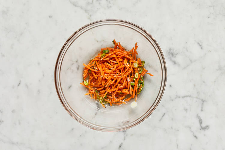 Cook zucchini and make carrot slaw