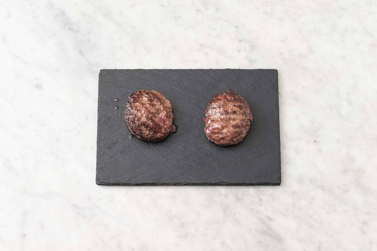 Toast buns and melt cheese