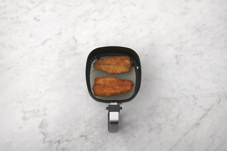 Cook the crumbed basa