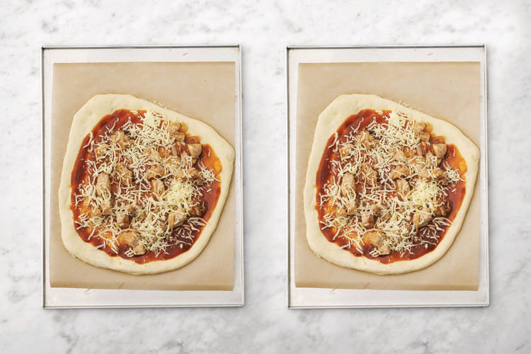 Top the pizzas