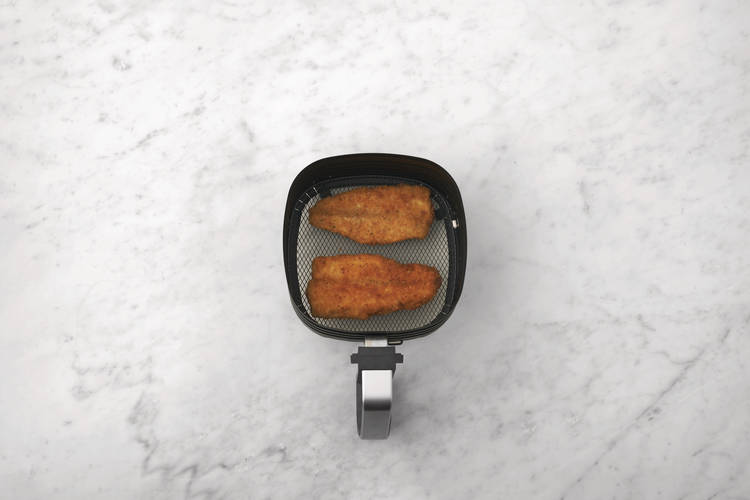 Cook the crumbed basa