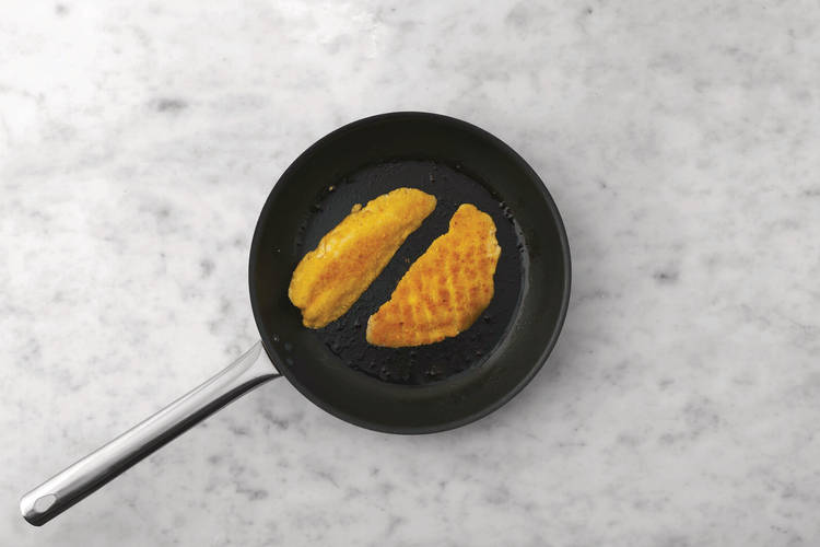 Cook the crumbed basa