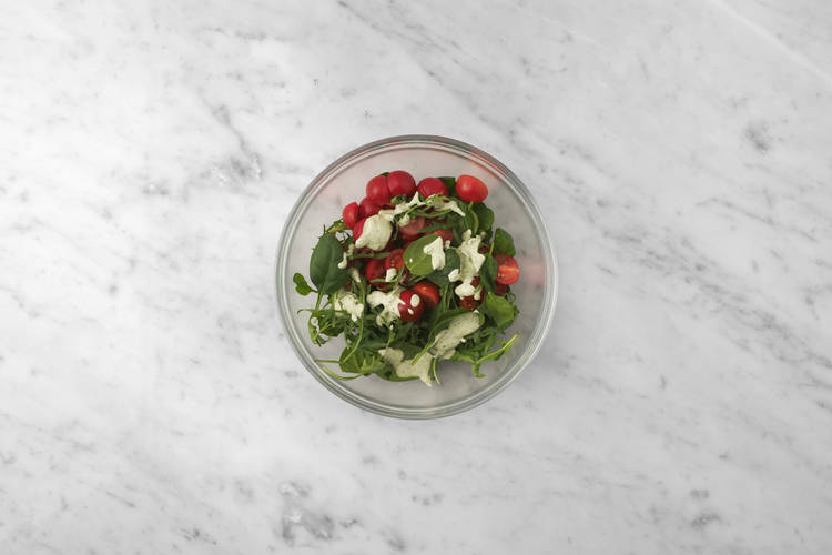 Heat the pita pockets & toss the salad