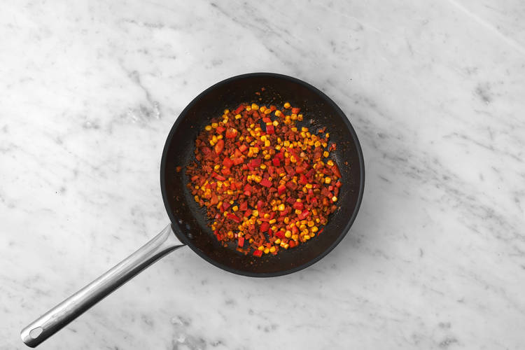 Cook chorizo and prep peppers