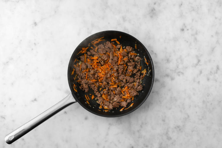 Cook plant-based protein shreds and veggies