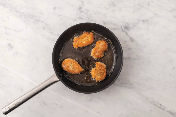 Cook the plant-based crumbed chicken 