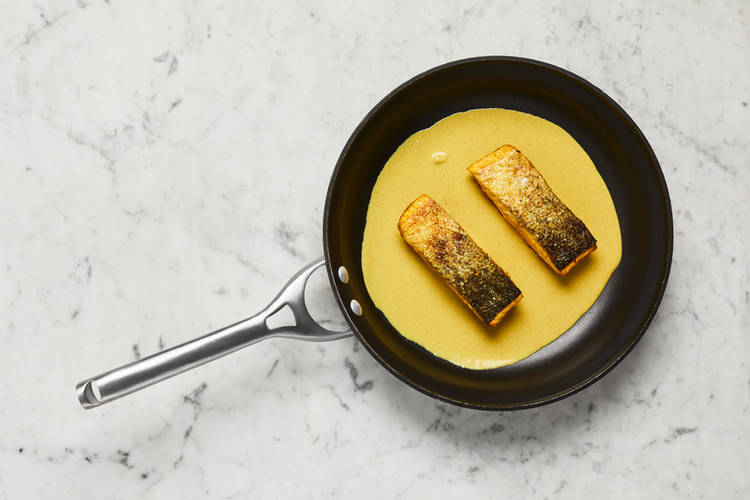 Cook curry sauce and salmon