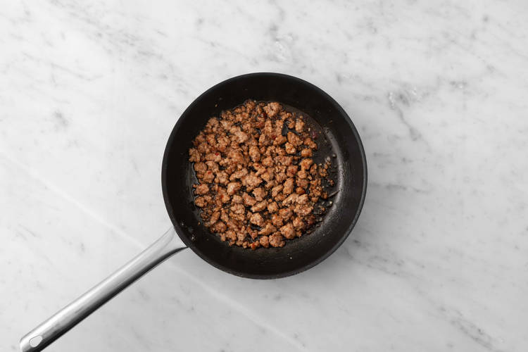 Cook plant-based protein shreds and onions