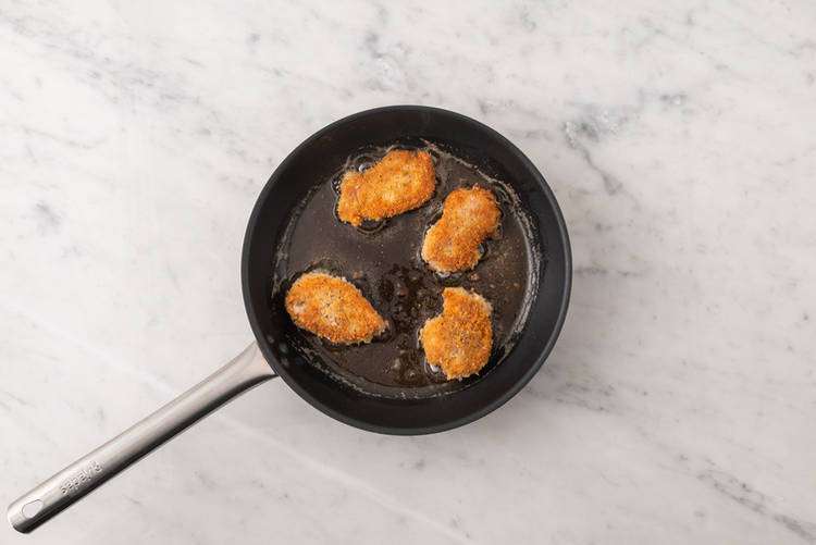 Cook the plant-based crumbed chicken 