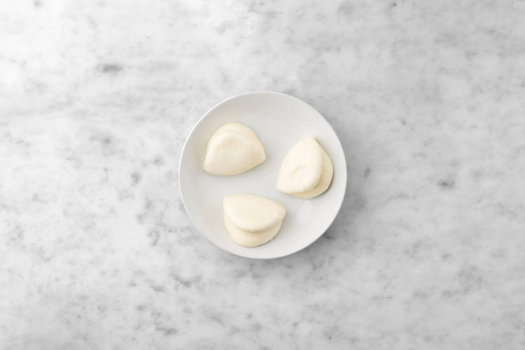 Heat the bao buns & toss the salad