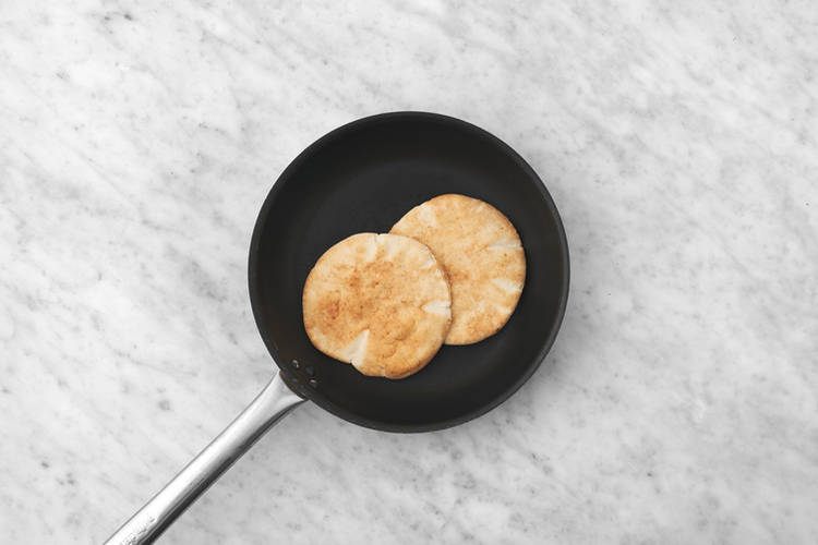 Warm the pita breads