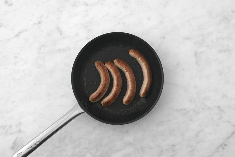 Char the onions & cook the sausages