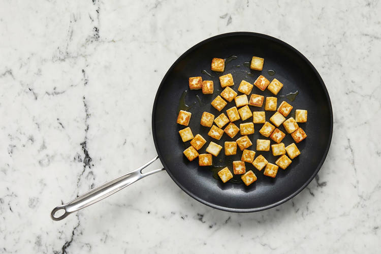 Fry halloumi and start tomato sauce