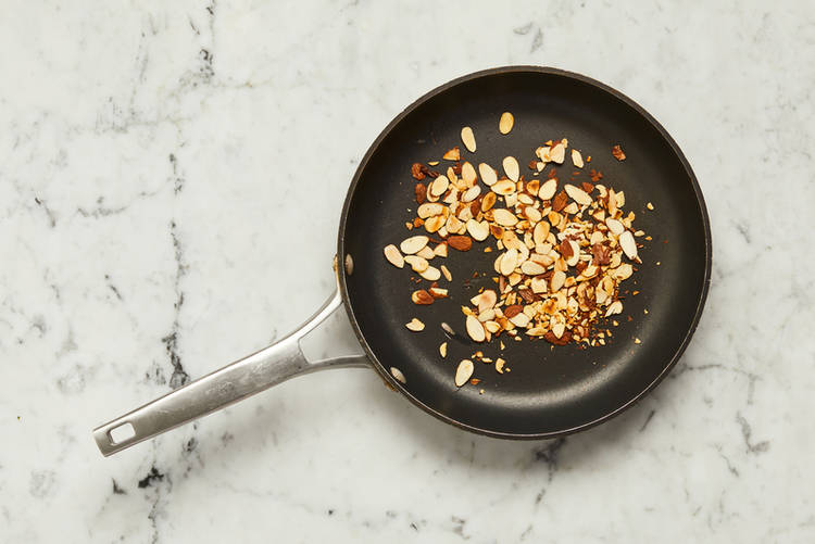 Toast almonds and cook carrots