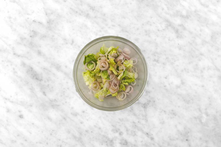 Dress lettuce and shallots