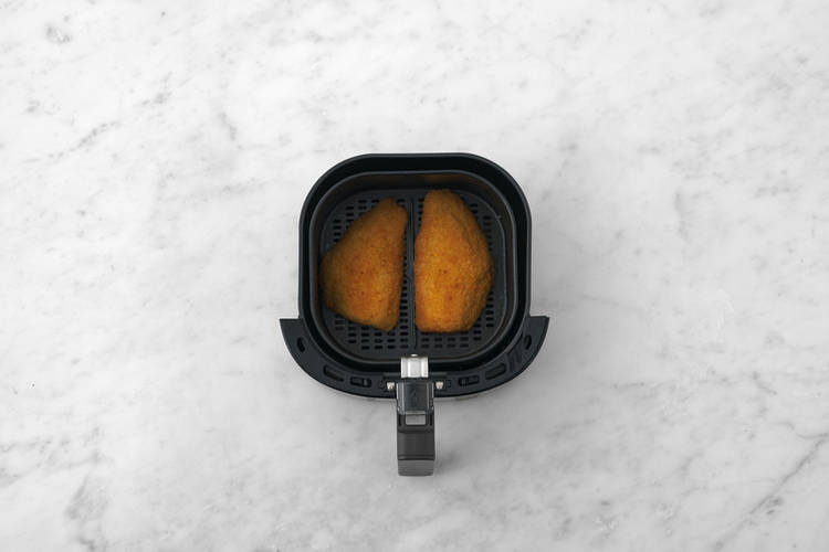 Cook the plant-based crumbed chicken